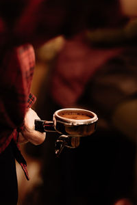 Cropped image of hand holding coffee