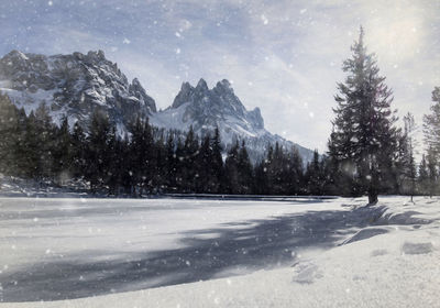 Scenic view of frozen mountains against sky