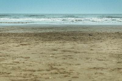 Scenic view of beach against clear sky