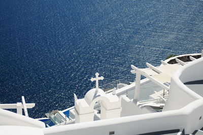 High angle view of white church by sea against sky