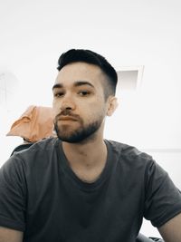 Portrait of young man against wall