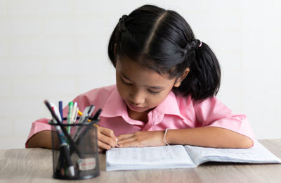 Portrait of a girl holding paper