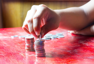 Cropped hand stacking coins