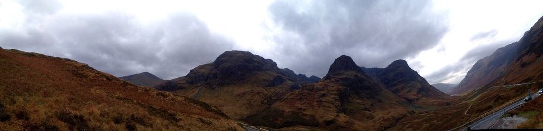 Scenic view of mountains against cloudy sky