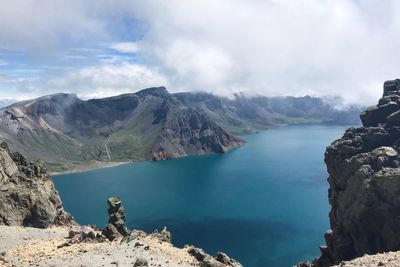 Panoramic view of sea and mountains against sky