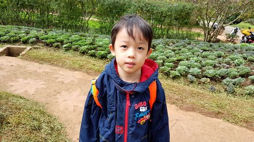 Portrait of cute boy standing outdoors