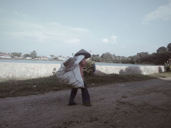 Rear view of man standing in water