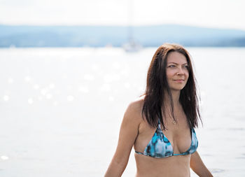 Young woman swims in the lake