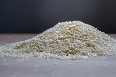 Close-up of bread on table against white background