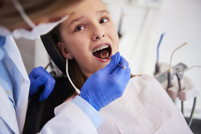 Dentist examining patient mouth in hospital