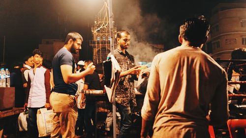 Men standing at music concert