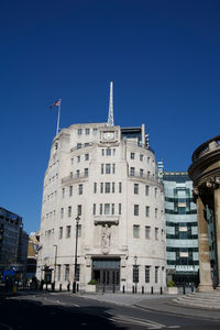 Low angle view of buildings against blue sky