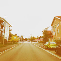 Street amidst buildings against clear sky