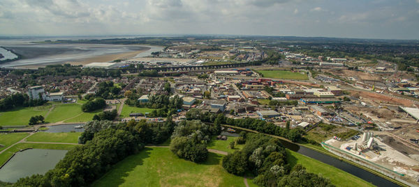 Aerial view of city against cloudy sky