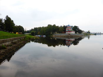 Reflection of building on lake against sky