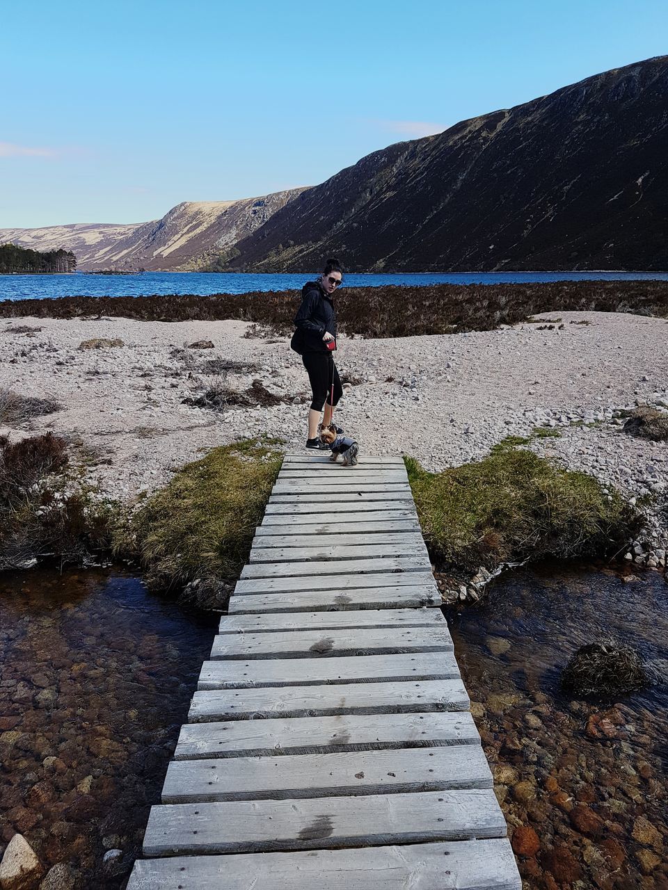 one person, full length, mountain, water, sky, nature, leisure activity, sea, beauty in nature, scenics - nature, lifestyles, day, shore, coast, walkway, adult, rear view, walking, clear sky, landscape, environment, footpath, non-urban scene, the way forward, rock, men, land, tranquility, outdoors, tranquil scene, activity, travel, travel destinations, women, motion, mountain range, hiking, vacation, sunlight, sunny, holiday, standing, person, trip, winter, sports