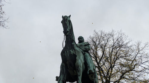 Low angle view of statue against sky