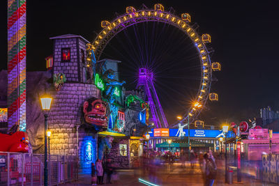 Illuminated ferris wheel at night