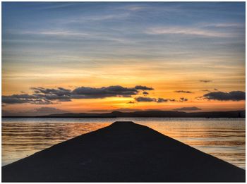 Scenic view of sea against sky at sunset