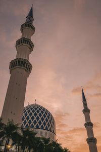 Low angle view of mosque against sky during sunset
