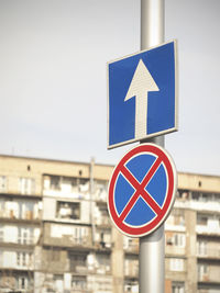 Road sign with a blurry building on background