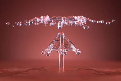 Close-up of water splashing against gray background