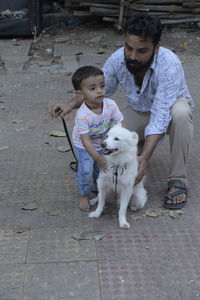 A dog with a small boy and the boy's father