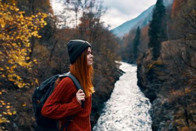 Woman standing in forest during autumn