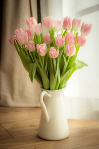 Close-up of pink roses in vase on table