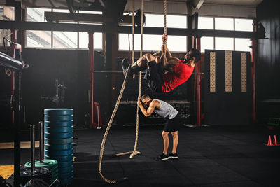 Rear view of man exercising in gym