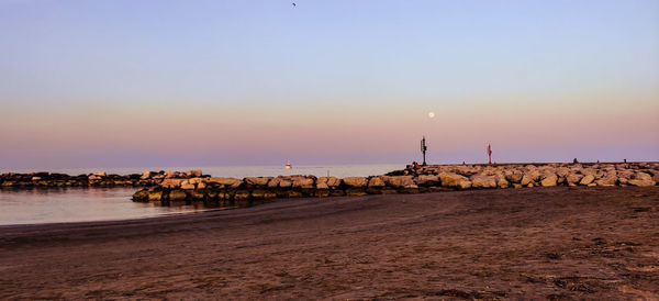 Scenic view of beach against sky during sunset