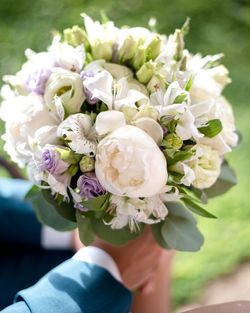 Close-up of person holding bouquet