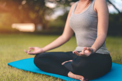Low section of woman exercising in park