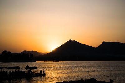 Scenic view of sea against orange sky