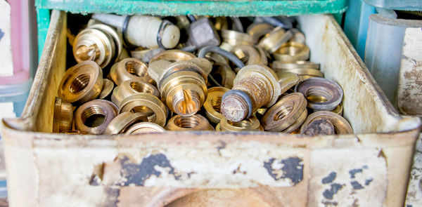 Brass nuts in plastic basket