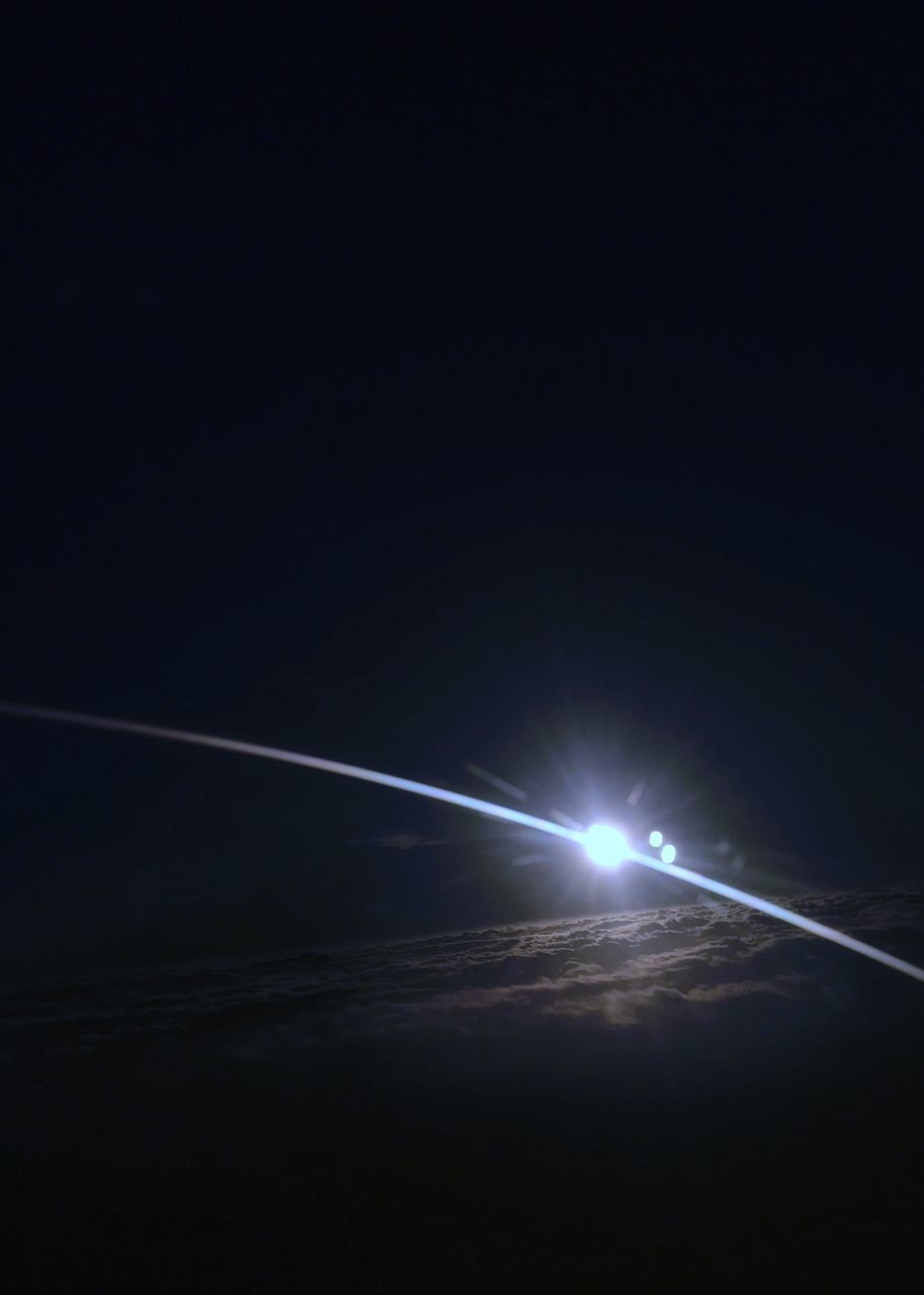 ILLUMINATED VAPOR TRAIL AT NIGHT