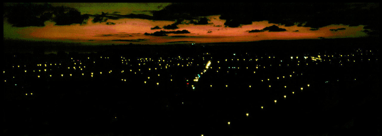 ILLUMINATED CITYSCAPE AGAINST SKY DURING SUNSET