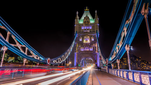 Light trails on tower bridge against clear sky at night