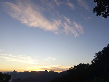 Scenic view of mountains against sky at sunset