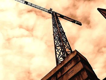 Low angle view of crane against sky