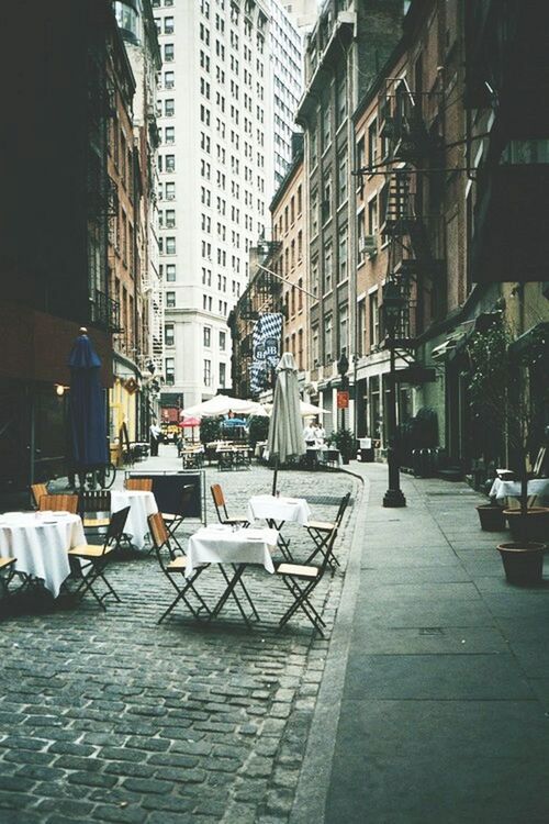 chair, building exterior, architecture, built structure, table, city, empty, absence, sidewalk cafe, restaurant, day, sunlight, seat, relaxation, residential building, residential structure, building, outdoors, no people, city life