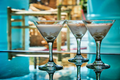 Close-up of wine glasses on table