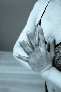 Midsection of woman with hands clasped