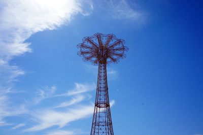 Low angle view of ferris wheel against blue sky