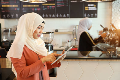 Midsection of woman holding smart phone