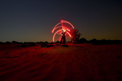 Woman with light trails at night