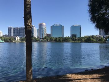 River by buildings against sky in city