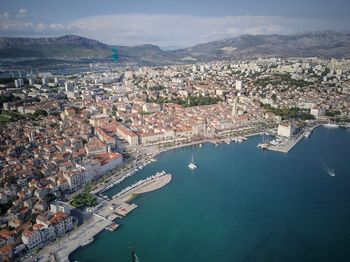 Aerial view of cityscape by sea