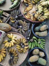 High angle view of fruits for sale in traditional market. pineaple, papaya, banana. tropical fruit