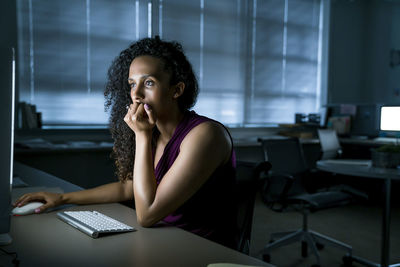 Businesswoman using desktop computer at desk in office